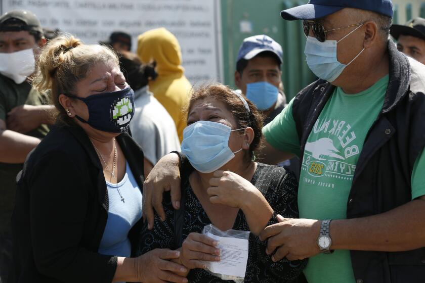 Isabel Cordero, center, and her relatives cry outside the General Hospital after receiving news that her husband Jose Luis Rojas died of respiratory distress, in Ecatepec, Mexico City, Saturday, May 2, 2020. The Ecatepec General Hospital is one of the hospitals designated by authorities to treat cases of new coronavirus. (AP Photo/Marco Ugarte)