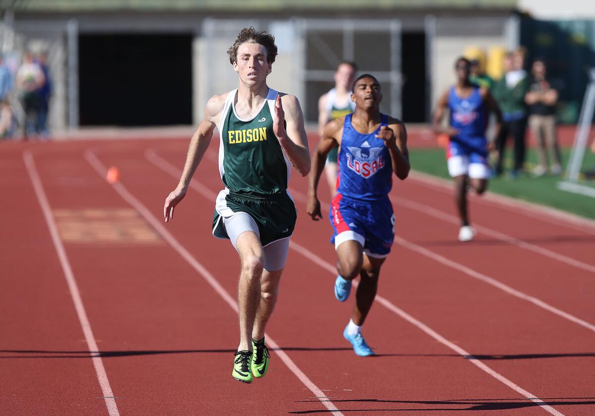 Edison's Ryan Rivituso eyes the finish line en route to winning the 400-meter event in the Surf League dual meet against Los Alamitos on Wednesday in Huntington Beach.
