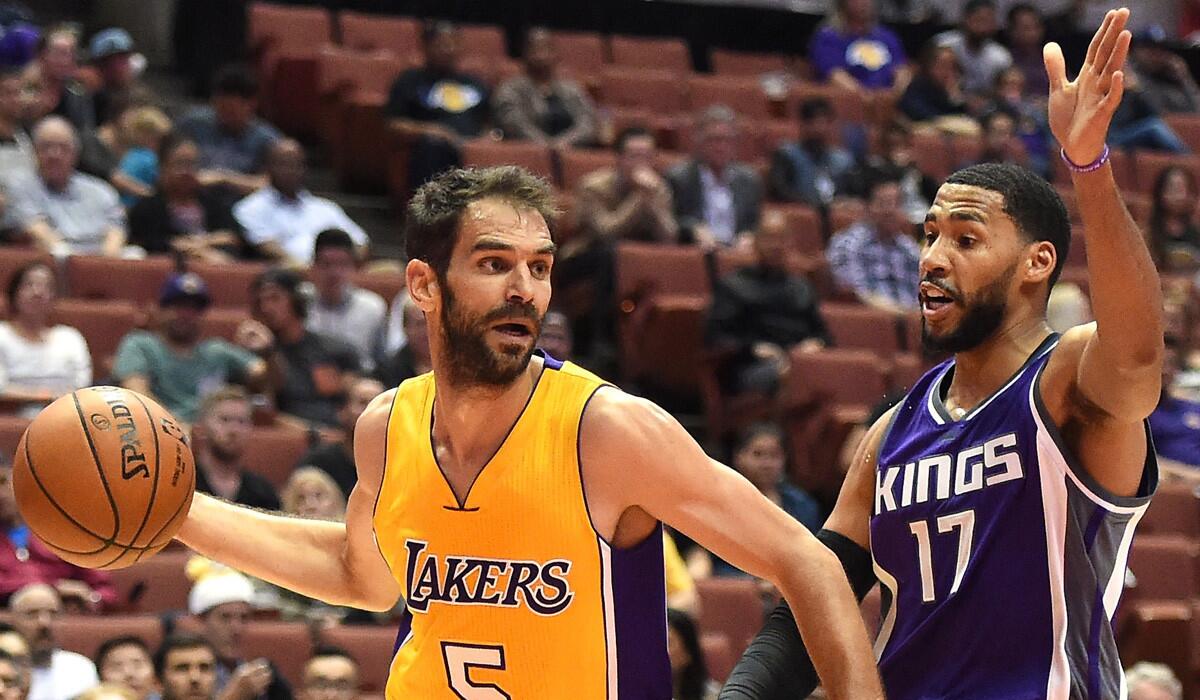 The Lakers' Jose Calderon drives against Sacramento's Garrett Temple on Oct. 4.