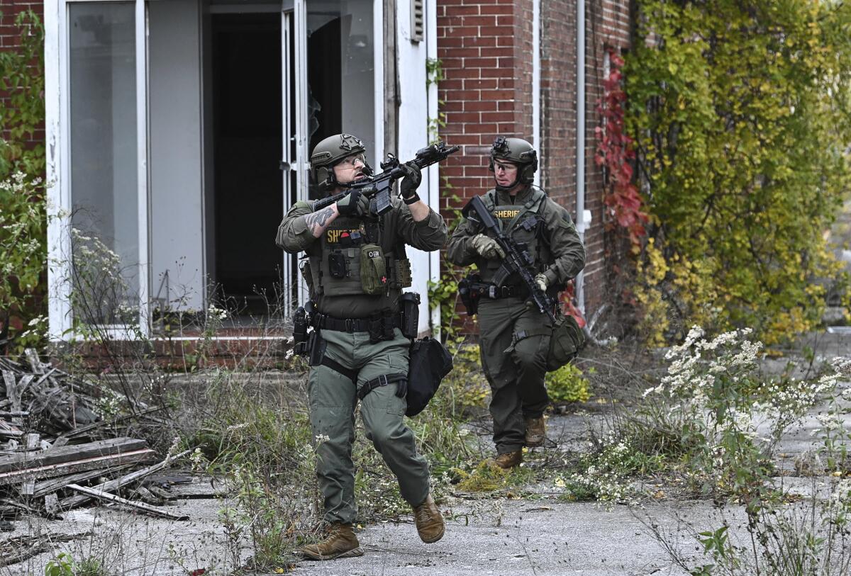 Frederick County, Md., Sheriff's Office SWAT Team officers searching for a suspect