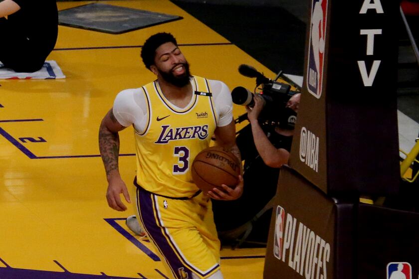 Lakers forward Anthony Davis winces in pain early in Game 6 against the Sun on June 3, 2021, at Staples Center.