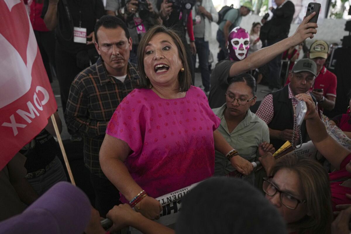 Xóchitl Gálvez in a pink top amid a campaign crowd 