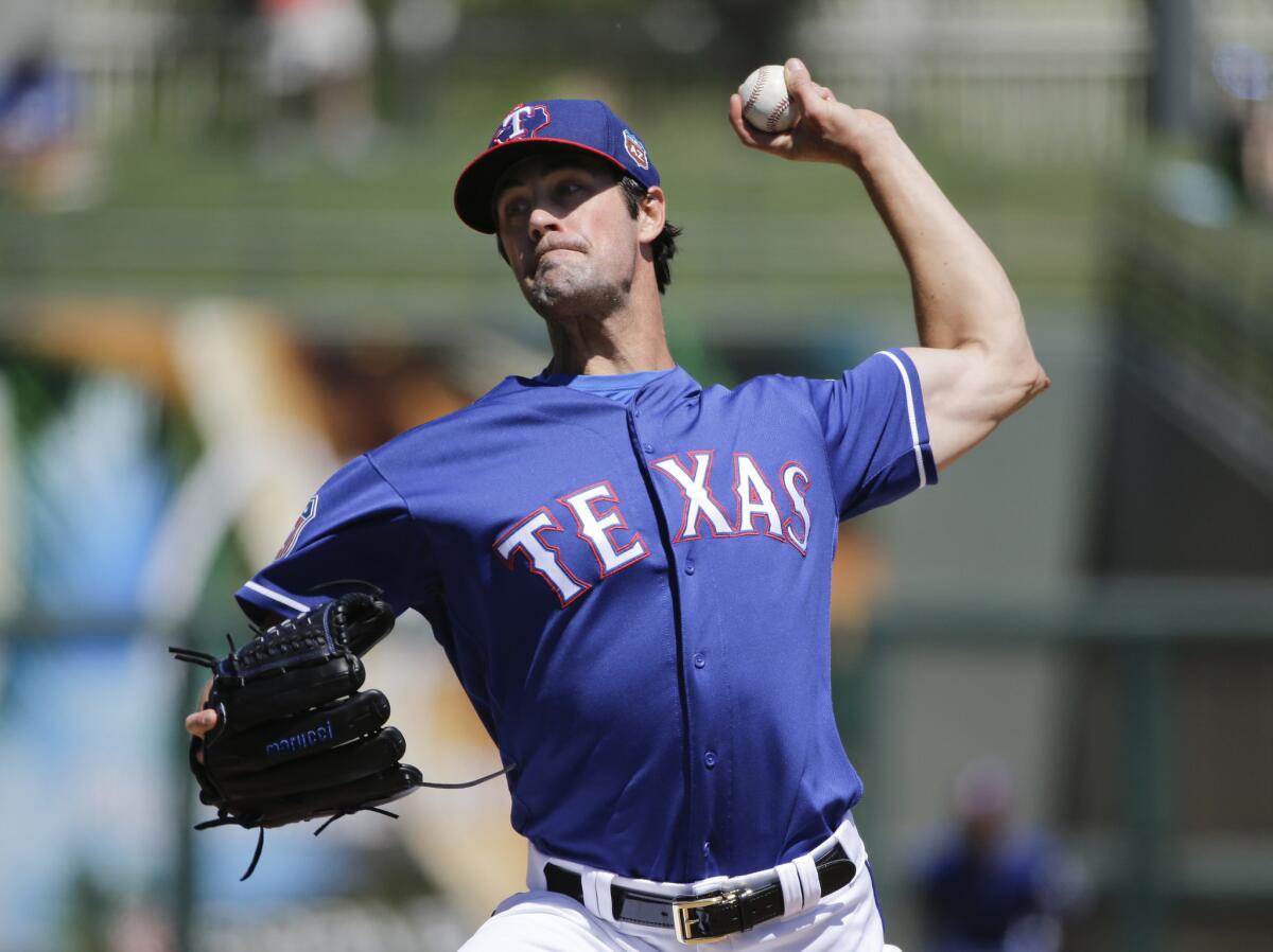 Rangers starting pitcher Cole Hamels throws against the Royals during the first inning of a spring training game on March 30.