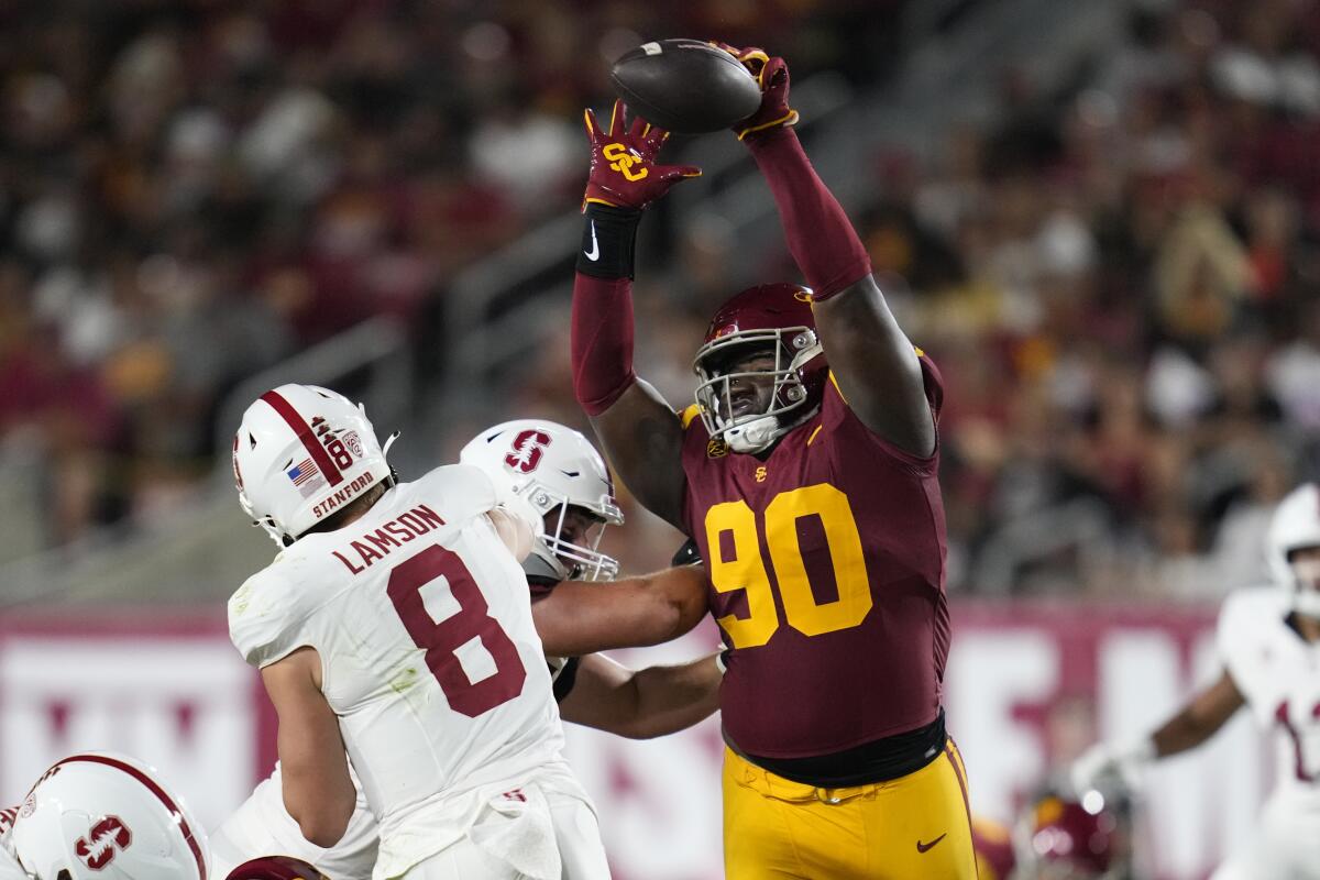 USC defensive lineman Bear Alexander stretches out his arms and blocks a pass by Stanford quarterback Justin Lamson 