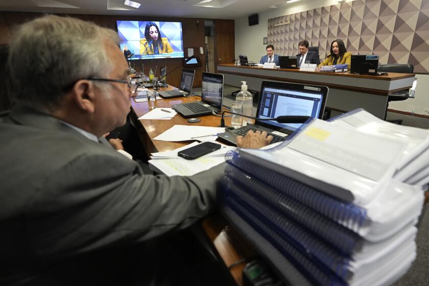 Senator Eliziane Gama, top right, reads her report and recommendation during a meeting by the Parliamentary Inquiry Committee that is investigating the Jan. 8 uprising in Brazil's capital, at the Federal Senate in Brasilia, Brazil, Tuesday, Oct. 17, 2023. (AP Photo/Eraldo Peres)