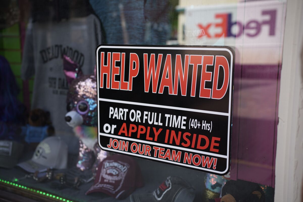 In this May 26, 2021 photo, a sign for workers hangs in the window of a shop along Main Street in Deadwood, S.D. U.S. employers added 559,000 jobs in May, an improvement from April’s sluggish gain but still evidence that many companies are struggling to find enough workers as the economy rapidly recovers from the pandemic recession. (AP Photo/David Zalubowski)