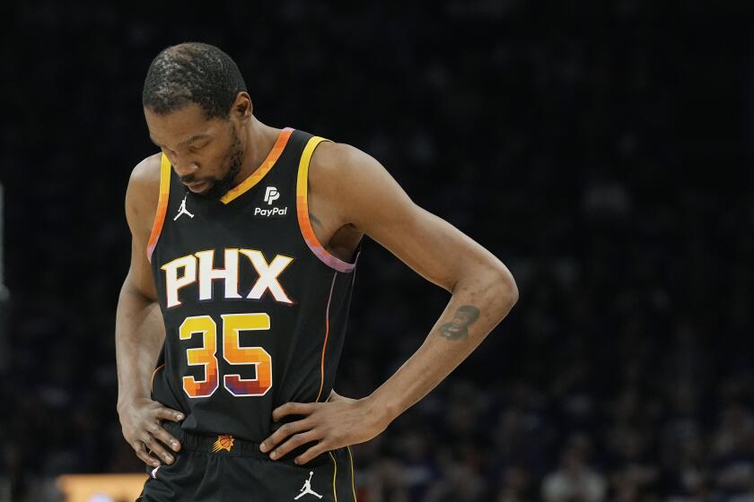 Phoenix Suns forward Kevin Durant pauses on the court during the first half of Game 4 of an NBA basketball first-round playoff series against the Minnesota Timberwolves, Sunday, April 28, 2024, in Phoenix. The Timberwolves won 122-116, taking the series 4-0. (AP Photo/Ross D. Franklin)