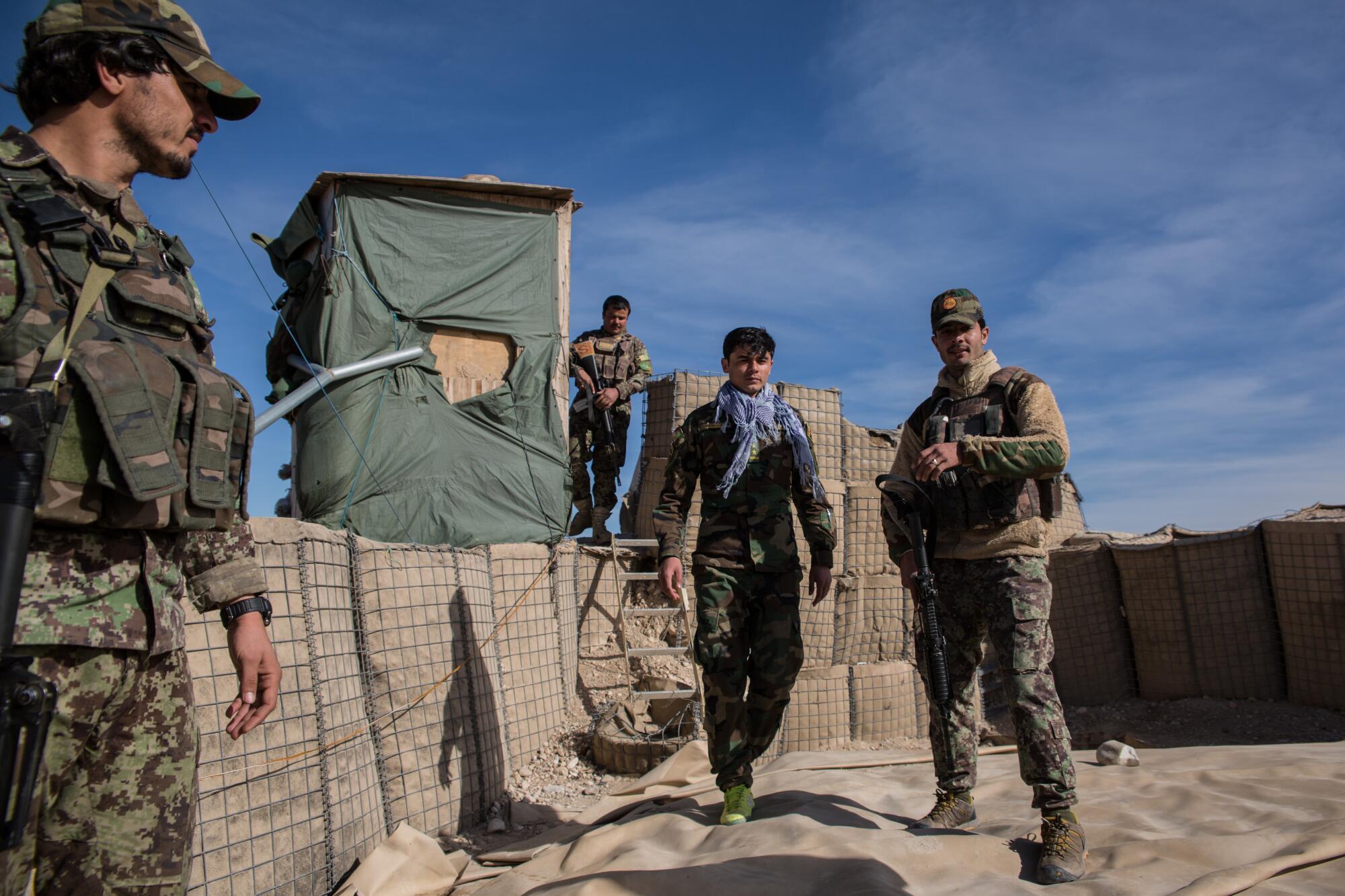 Soldiers man their hilltop outpost in the Tarnak Wa Jaldak district. 