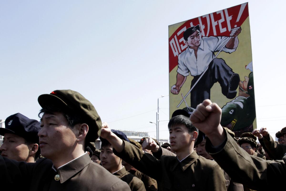 North Koreans punch the air during a rally at Kim Il Sung Square in downtown Pyongyang, North Korea.