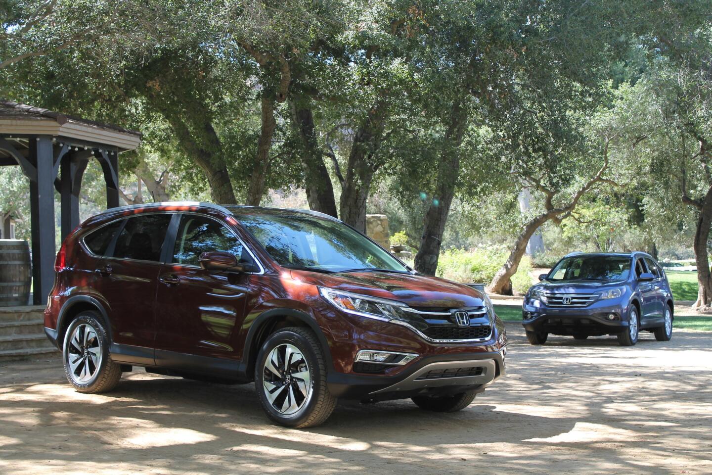 The 2015 Honda CR-V, left, parked next to a 2014 model, showing the subtle changes Honda made to the crossover's exterior.