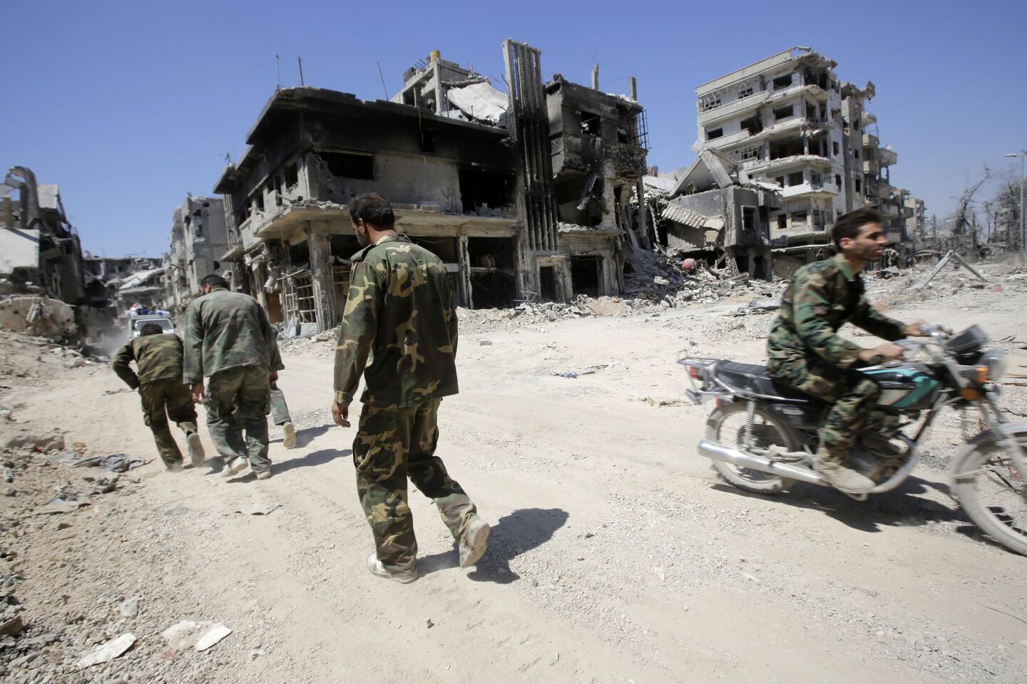 Syrian government forces patrol the Khaldiyeh district of Syria's central city of Homs. The Syrian government announced on July 29 the capture of Khaldiyeh, a key rebel district in Homs.