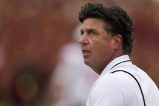 Oklahoma State head coach Mike Gundy watches from the sideline during the first half of a game against Iowa State