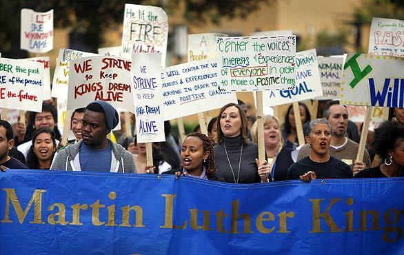 A group of about 100 UC Irvine students and faculty participate in the annual Martin Luther King Jr. march and rally on campus Wednesday.