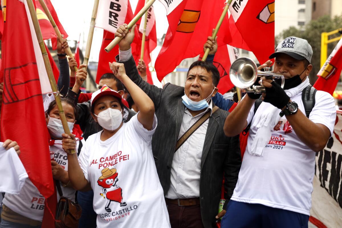 Supporters of Free Peru party presidential candidate Pedro Castillo hold up banners.