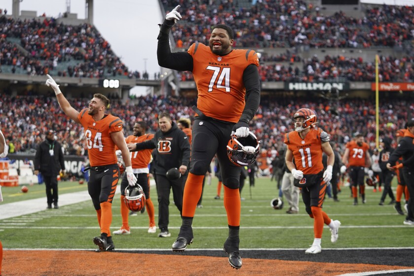 Cincinnati Bengals offensive tackle Fred Johnson (74) celebrates with teammates after the Bengals defeated the Kansas City Chiefs 34-31 in an NFL football game, Sunday, Jan. 2, 2022, in Cincinnati. (AP Photo/Jeff Dean)