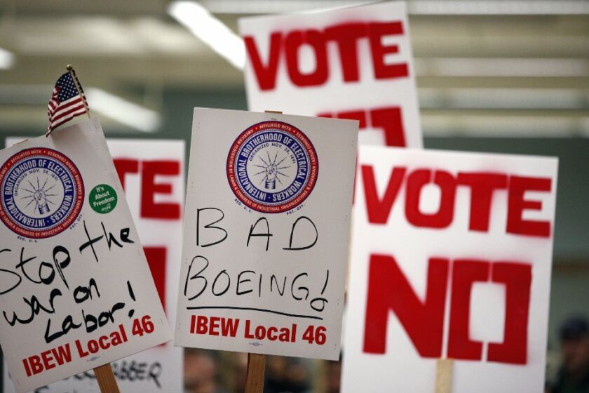 Signs at a rally prior to Friday's Boeing contract vote; the contract passed.