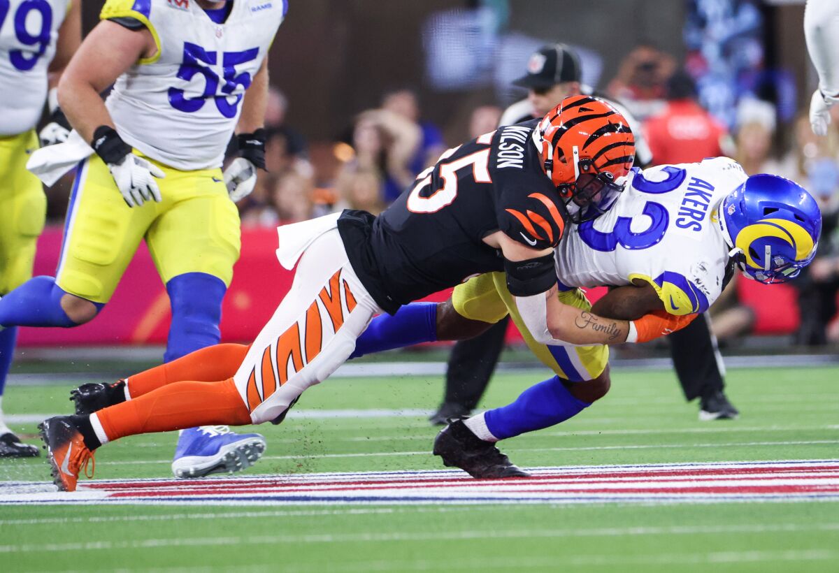Rams running back Cam Akers is tackled by Cincinnati Bengals linebacker Logan Wilson.
