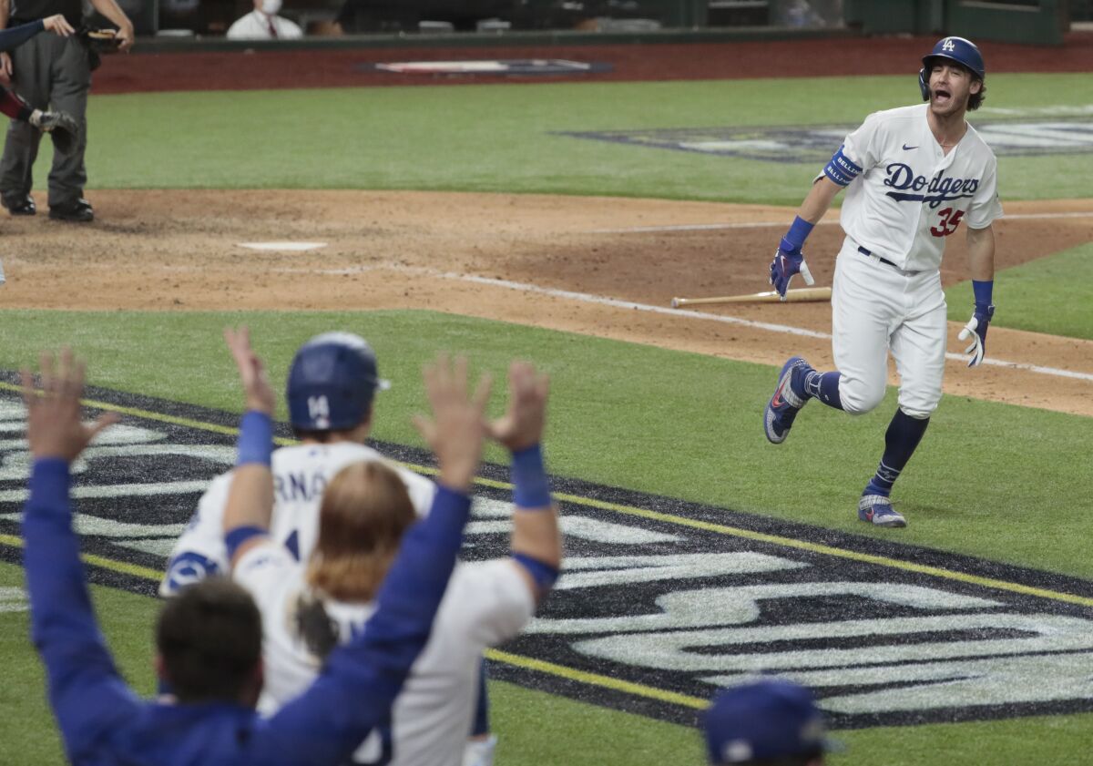 Cody Bellinger celebrates in front of the Dodgers' dugout during the playoffs.