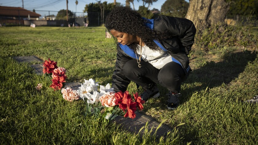Celestina Bishop visits the graves of her mother and sisters at Woodlawn Memorial Park.