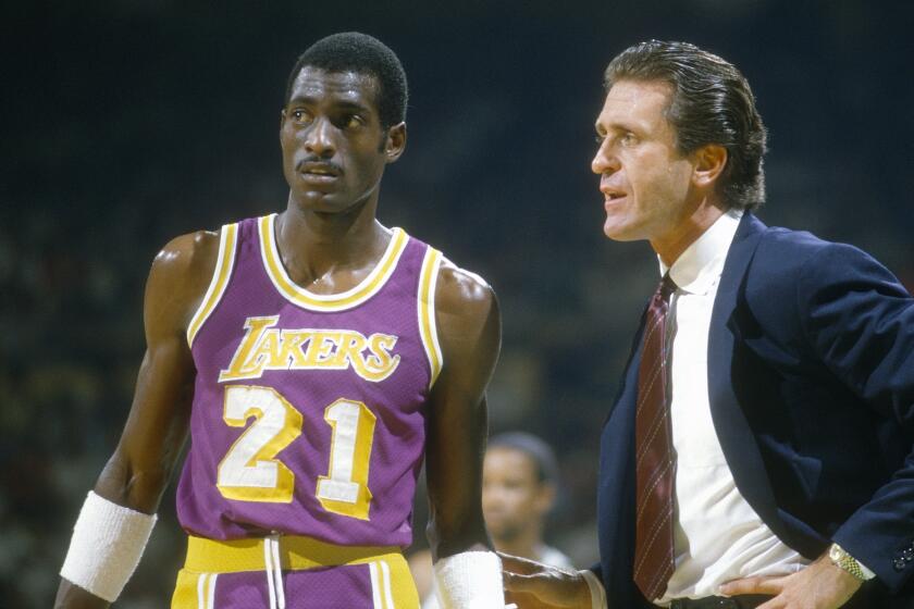 UNSPECIFIED - CIRCA 1985: Head Coach Pat Riley of the Los Angeles Lakers talks with Michael Cooper.