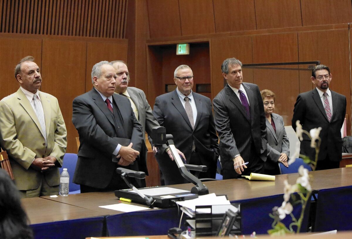 Five former Bell City Council members, seen here with their lawyers, asked for more time Friday to consider whether to accept a deal in which they could get four-year prison sentences in exchange for pleading guilty to corruption charges.