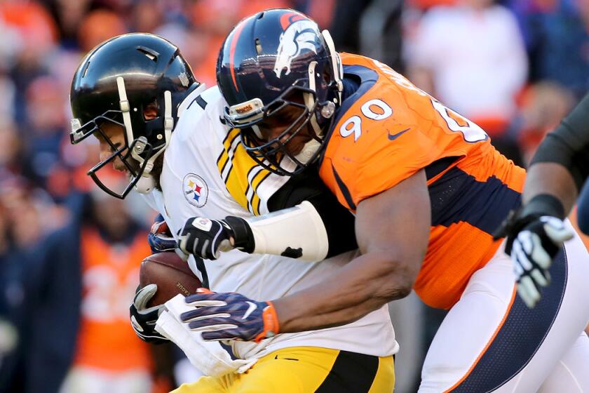 Pittsburgh Steelers quarterback Ben Roethlisberger, left, gets sacked by Denver Broncos' Antonio Smith during the AFC Divisional Playoff Game on Jan. 17.