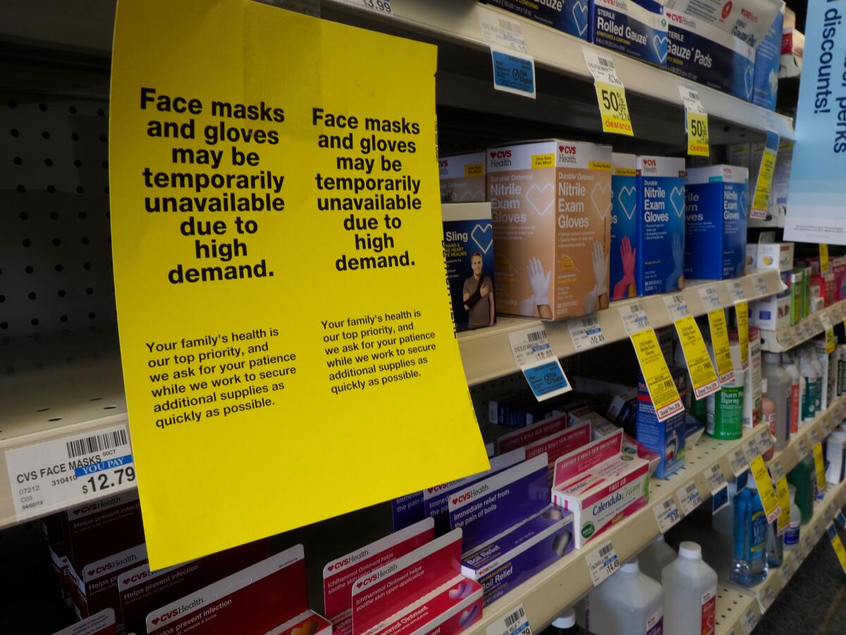 A shelf of sold-out protective masks and low supply of protective gloves at a CVS in Oakland on Feb. 27.