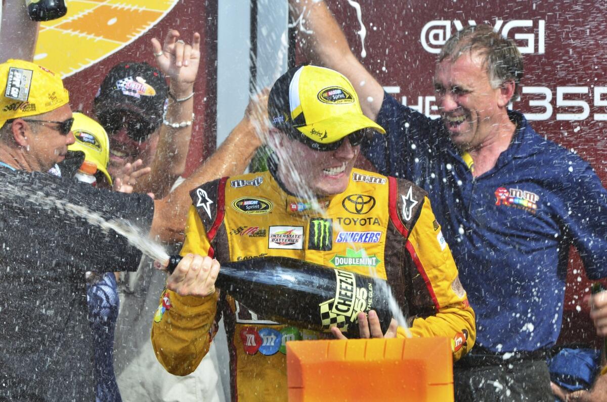 Kyle Busch celebrates after winning the NASCAR Sprint Cup race at Watkins Glen International on Sunday.