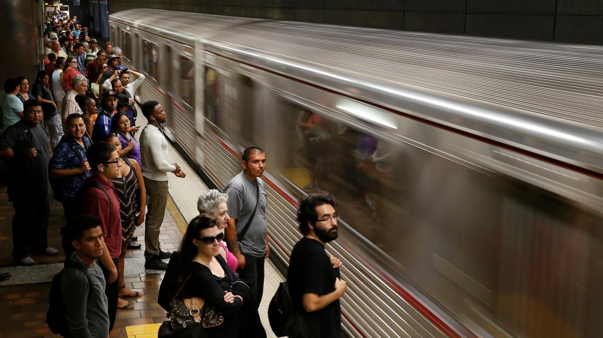 Commuters wait for an eastbound train at the 7th Street/Metro Center subway station.