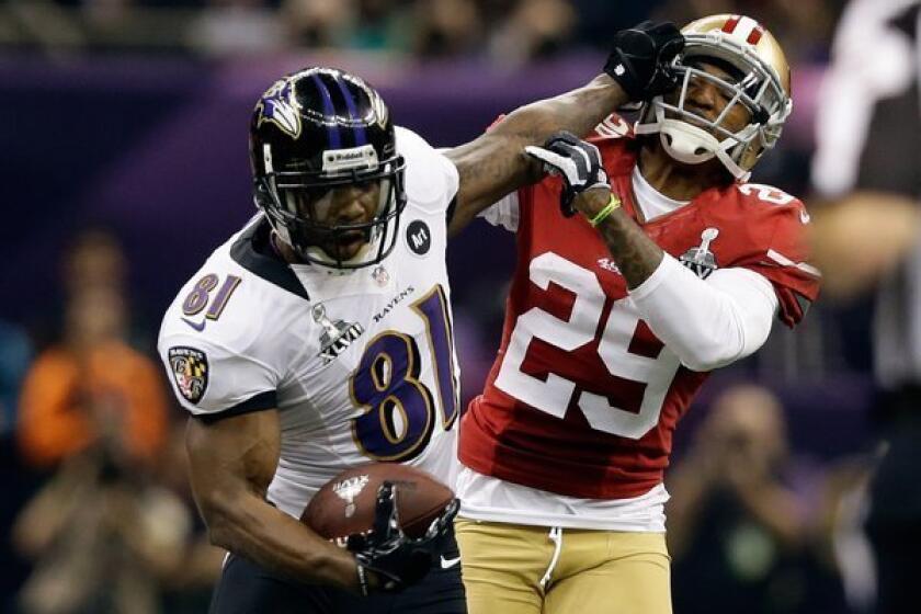 Baltimore receiver Anquan Boldin stiff-arms San Francisco's Chris Culliver during the Super Bowl.