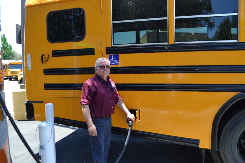 Ed Gonzalez, vehicle maintenance supervisor for Poway schools, charges a new electric bus on Thursday.