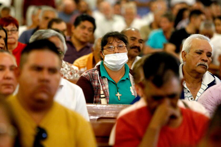 Faithfull take part in a Sunday mass wearing protective face masks as a preventive measure in the face of the global COVID-19 coronavirus pandemic, at the Guadalajara Metropolitan Cathedral, Mexico, on March 15, 2020. - Mexican government recognizes 41 cases of Covid 19 so far. (Photo by Ulises Ruiz / AFP) (Photo by ULISES RUIZ/AFP via Getty Images)
