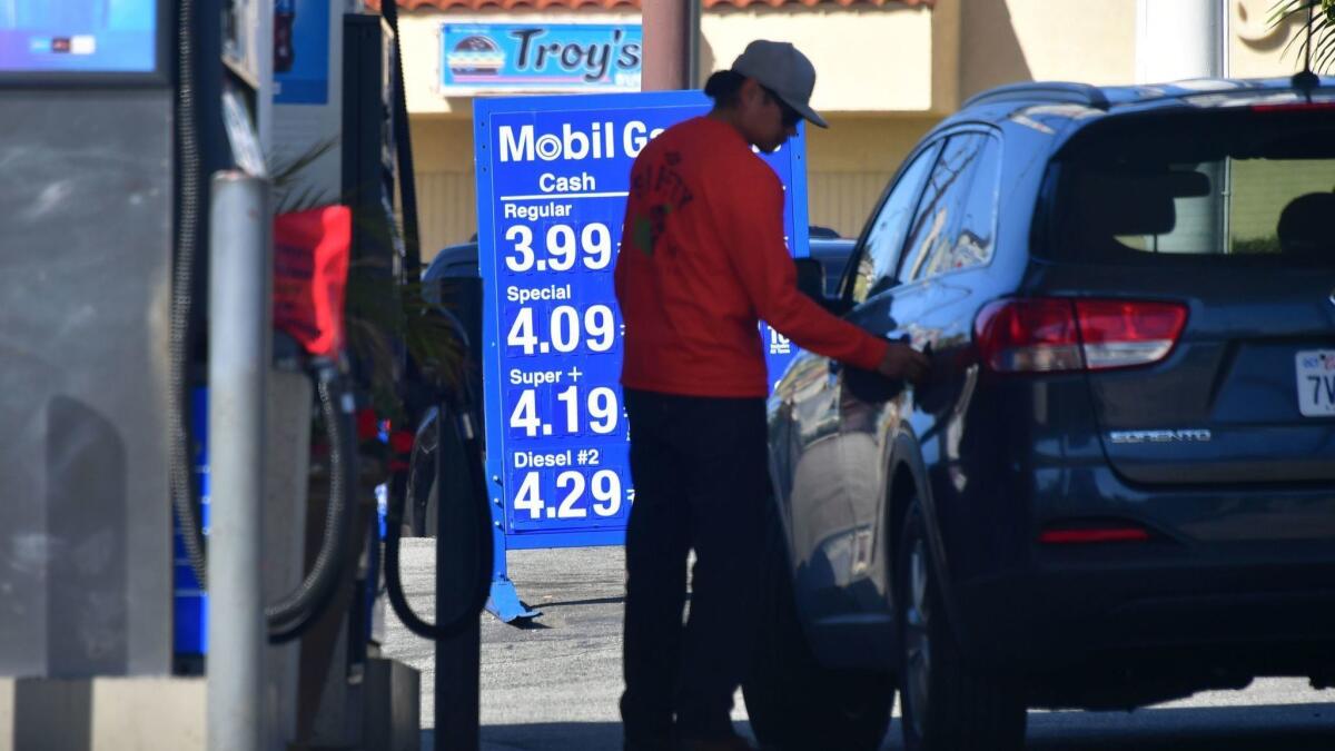 A driver closes the cap after filling up at a Los Angeles gas station on April 9. The average price per gallon in the Los Angeles and Long Beach area increased to $4.069 this week, compared with $3.888 last week.