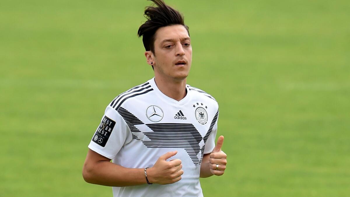 Germany midfielder Mesut Ozil has resumed light training after injuring a knee in a 2-1 victory over Austria.