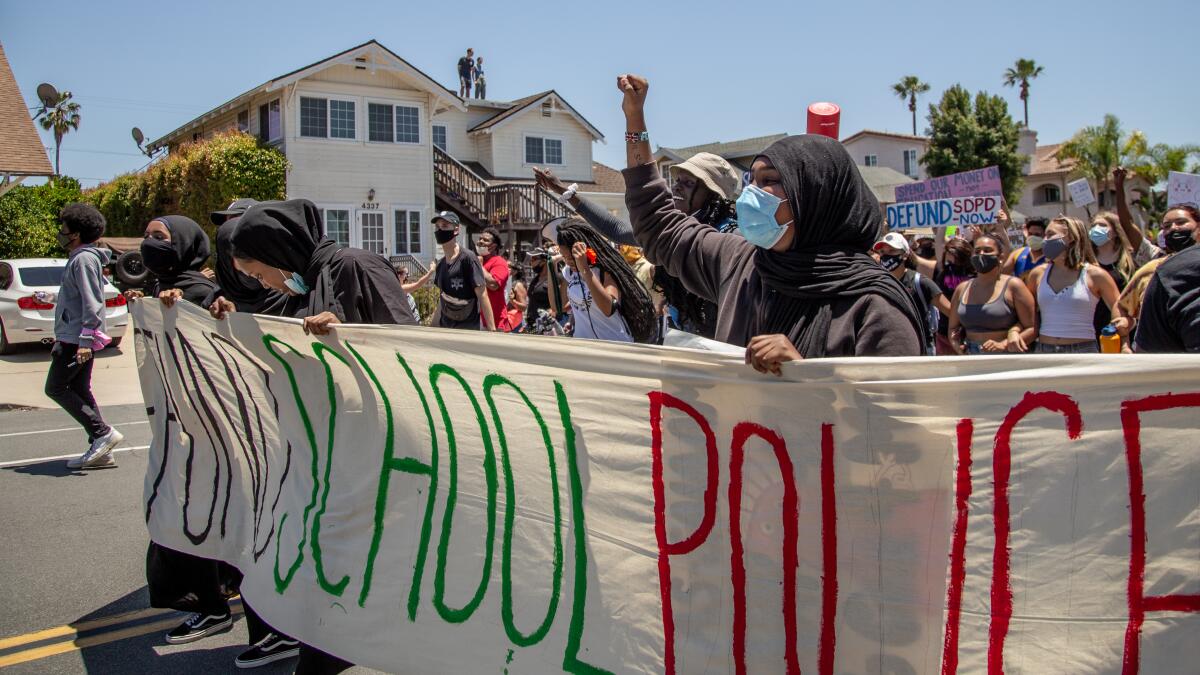 Protestors in support of defunding school police march through University Heights on July 2, 2020.