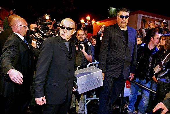The first Apple iPhone 3G for sale in Belgium arrives in style, with bodyguards, at a Mobistar center in Brussels late Thursday. The first phone was sold at a minute past midnight.