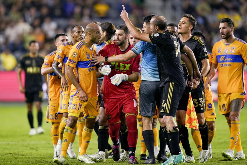 Tigres UANL midfielder Guido Pizarro, left, is separated from Los Angeles FC defender Giorgio Chiellini, right, during the first half of a Campeones Cup soccer match Wednesday, Sept. 27, 2023, in Los Angeles. (AP Photo/Ryan Sun)