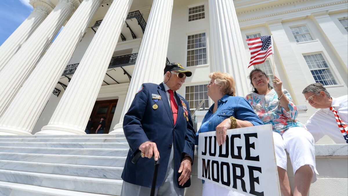 Supporters of suspended Alabama Chief Justice Roy Moore gather at the state Capitol in Montgomery to hear him announce his bid for a U.S. Senate seat.