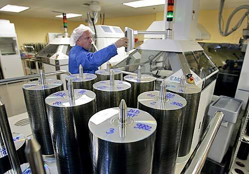 Tony Cifarelli, a church staffer at Golden Era Productions, monitoring machinery in the CD and DVD replication plant. The studio manufactures 10 million CDs each year that are later sold to church members around the world.