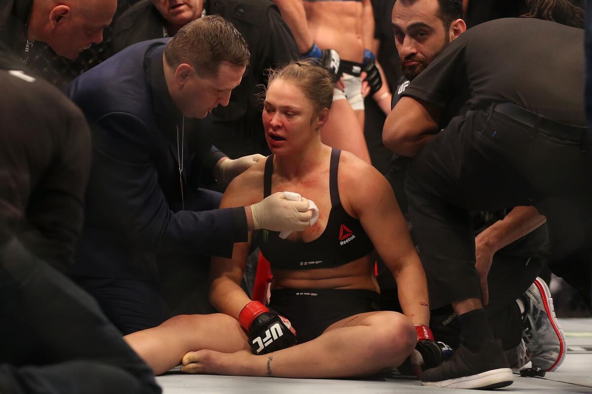 Ronda Rousey receives medical treatment after being knocked out by Holly Holm.