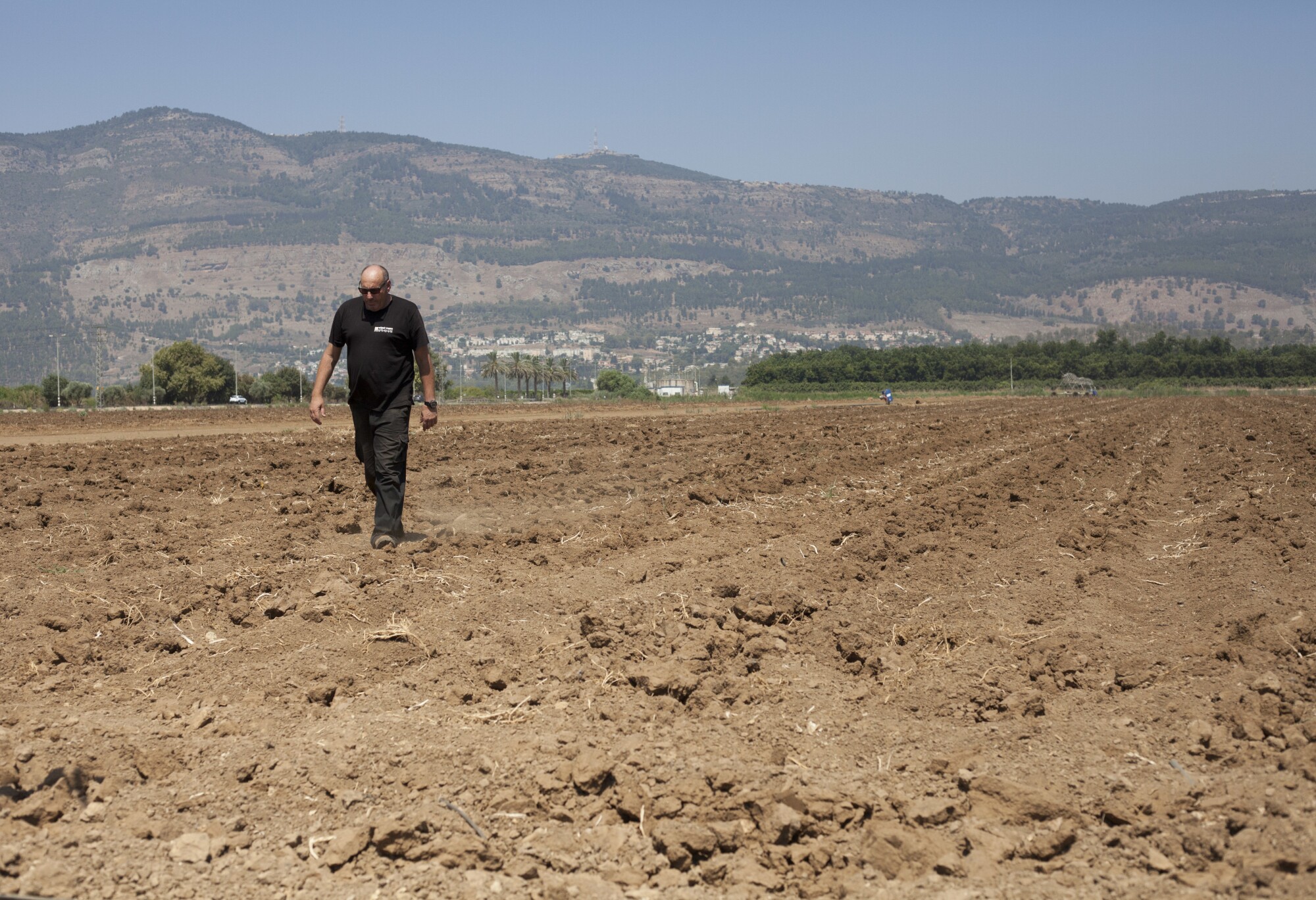 Israeli farmer Ofer Moskovitz walks through his field near Kfar Yuval, Israel.