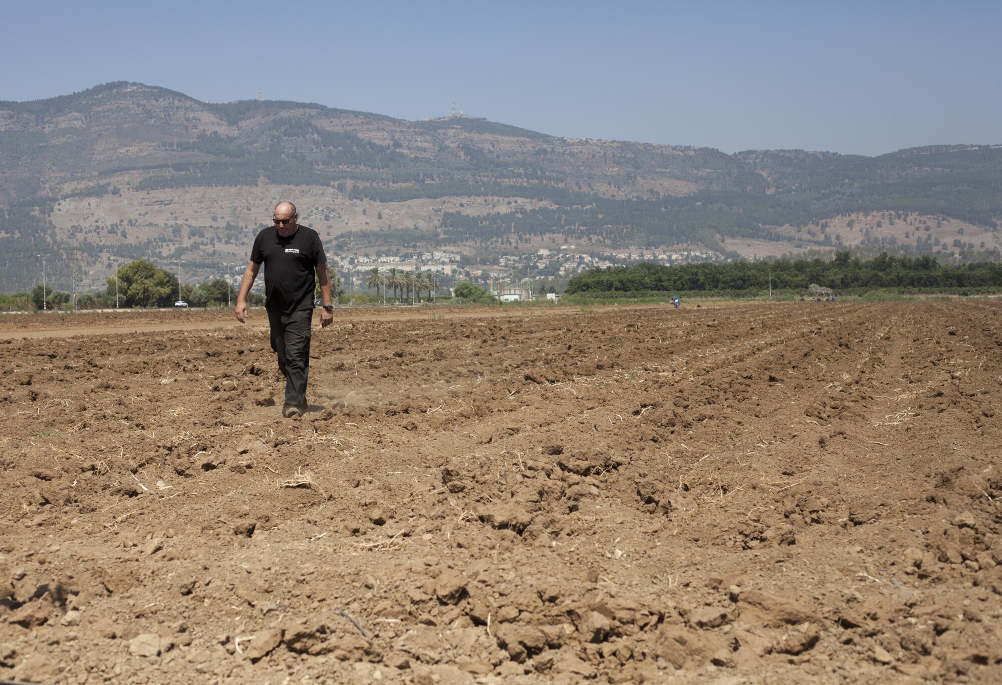 Israeli farmer Ofer Moskovitz walks through his field near Kfar Yuval, Israel.