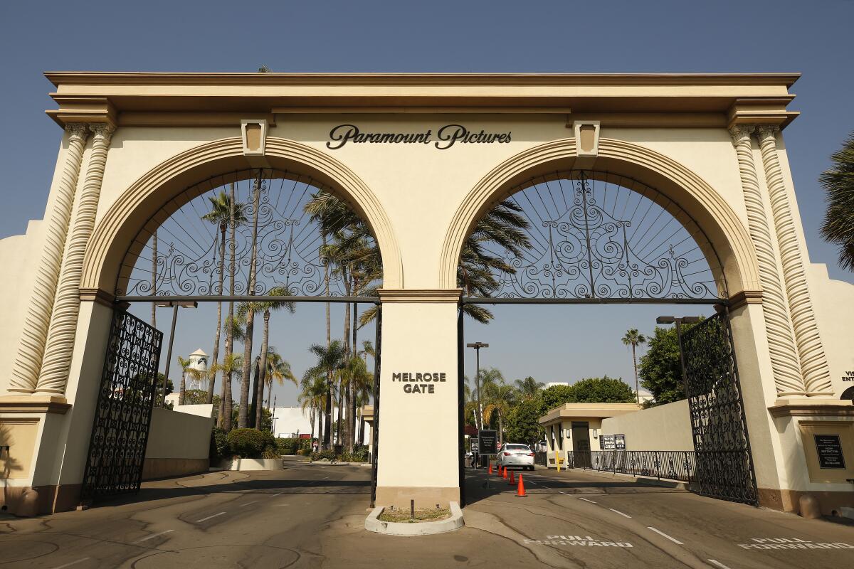 The double-arch entryway to Paramount Pictures with palm trees in the background.