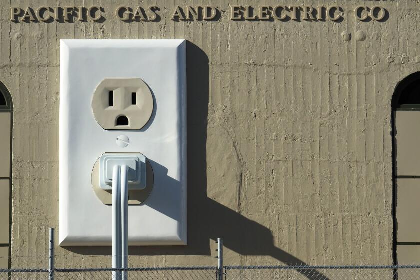 An art installation entitled 'Outlet-plug-cord' (2015) by Basal Ganglia Studio is displayed on the side of a Pacific Gas & Electric substation in Petaluma, California on July 16, 2015.