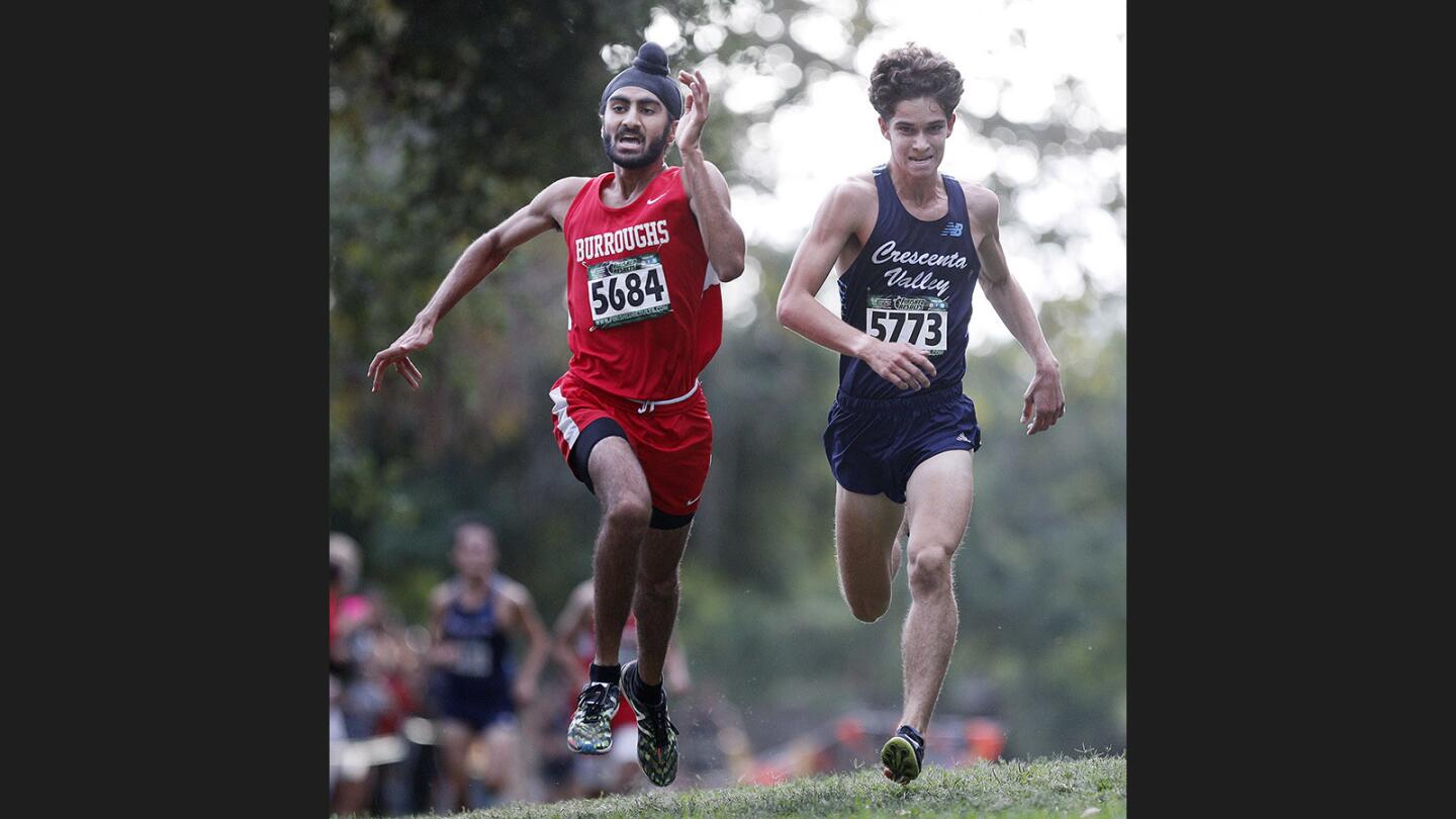 On the final stretch to the finish, Burroughs' Jagdeep Chahal and Crescenta Valley's Colin FitzGerald run neck-and-neck in the Pacific League varsity boys' cross country championship at County Park in Arcadia on Wednesday, November 1, 2017. Chahal won the race by hundredths of a second.