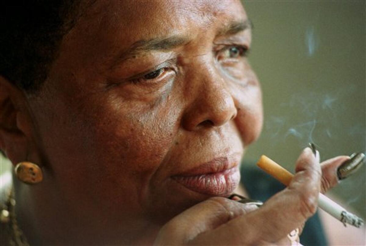 FILE - In this Sept. 7, 2000 file photo, singer Cesaria Evora, known as the "Barefoot Diva," smokes a cigarette during an interview at her home in Mindelo, on the Cape Verde island of Sao Vicente. Evora, who started singing as a teenager in the bayside bars of Cape Verde in the 1950s and won a Grammy in 2003 after she took her African islands music to stages across the world, died Saturday, Dec. 17, 2011. She was 70. (AP Photo/Armando Franca, File)