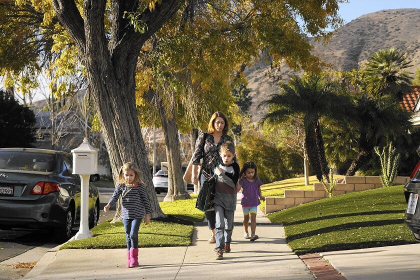 Porter Ranch resident Dee Ann Abernathy walks her children home from school in December. Abernathy said her 6-year-old daughter Nalalie, left, had experienced headaches and other health problems since the Aliso Canyon gas leak began in October.