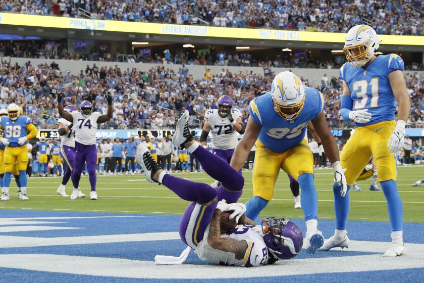 Inglewood, CA, Sunday, November 14, 2021 - Minnesota Vikings tight end Tyler Conklin (83) catches a touchdown pass over Los Angeles Chargers defensive end Jerry Tillery (99) on a third quarter drive at SoFi Stadium. Robert Gauthier/Los Angeles Times)
