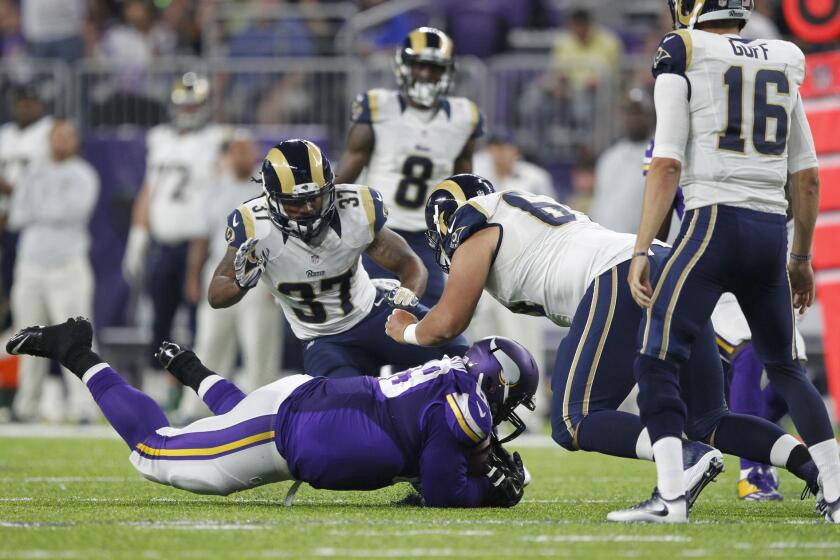 Vikings defensive tackle Toby Johnson dives to intercept a tipped pass of Rams quarterback Jared Goff (16) during the first half.