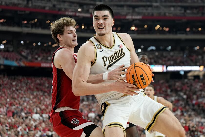 Purdue center Zach Edey, right, backs down NC State forward Ben Middlebrooks during the second half of the NCAA college basketball game at the Final Four, Saturday, April 6, 2024, in Glendale, Ariz. (AP Photo/Brynn Anderson )